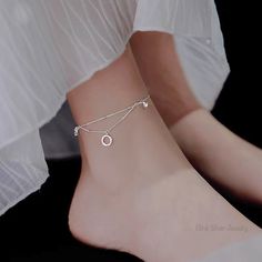 "Why not stand out a bit with this elegant accessory for your heels. Featuring a sparkling circle that dangles and swings along with every movement, this anklet is a true eye-catcher for any outfit you choose to wear it with DETAILS ・2 cm (0.78″) drop ・Length: 23 cm (9″) with 1.5 cm (0.6″) extender ・High-quality 925 Sterling Silver ・Rhodium-plating finish ・5A Grade Zirconia Crystal ・Hook closure ・Hypoallergenic and nickle-free WHY BLINK? ❥ We want to create affordable yet sustainable jewelries that is inclusive to everyone and everyday wear. Forget about fast fashion with fast-to-fade jewelries. We offer 100% real silver jewelry that is water resistant, tarnish-free and would always hold its value even after countless wear. Pure 925 Silver is the perfect material for making jewelry that su Dangle Anklets For Parties, Silver Minimalist Anklets For Party, Cute Anklets, Sterling Silver Anklet, Silver Anklets, Sustainable Jewelry, Velvet Bag, Elegant Accessories, Anklet Jewelry