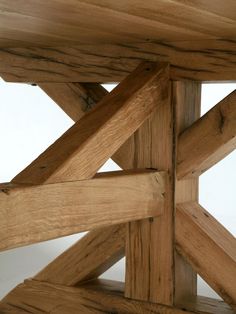 a close up view of the top of a wooden table with exposed wood slats