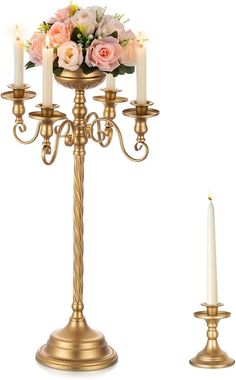 a gold candelabra with candles and flowers on it, set against a white background