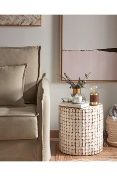 a living room with a couch, chair and table