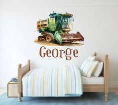 a bedroom with a wall decal that says george on it and a tractor in the background