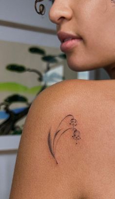 a woman with a tattoo on her shoulder