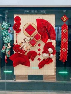 a display in a store window with red decorations