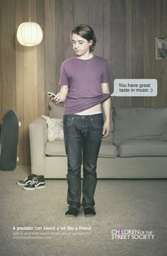 a girl standing in front of a couch holding a cell phone