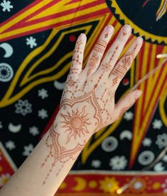 a person's hand with henna on it