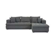 a gray sectional couch with pillows on it