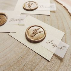 three buttons with names on them sitting on top of a piece of wood