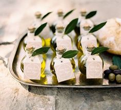 olives and oil in small bottles on a tray