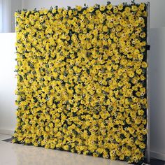 yellow flowers are growing on the side of a wall