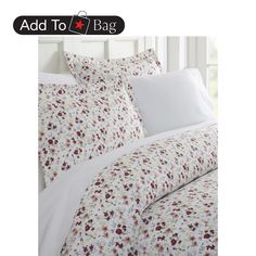 a bed with white sheets and red flowers on it, next to an image of a window