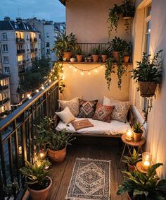 a balcony with potted plants and lights