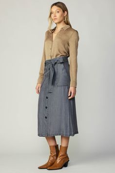 This mid-length skirt takes inspiration from vintage utilitarian style, reflected by wide belt loops and patch pockets at the front. Made from washed chambray in a soft black shade, it's detailed with a tie belt and buttons fastenings. •Wide belt loops •Optional self-tie belt •Patch pockets •Button front •Mid-length hem Item number 2350005 100% Tencel MACHINE WASH COLD LIKE COLORS Utility Style High-waist Medium Wash Denim Skirt, Mid-rise Skirt In Medium Wash With Button Closure, Mid-rise Cotton Denim Skirt With Belt Loops, Mid-rise Cotton Denim Skirt With Button Closure, Non-stretch Denim Skirt With Button Closure, Jacquard Blouse, Utility Skirt, Dressy Skirts, Utilitarian Style