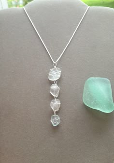 a necklace with three glass pieces hanging from it