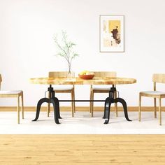 a dining room table with chairs and a bowl of fruit on top of the table