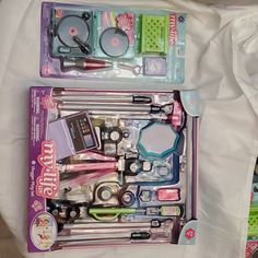 there are two sets of toys in the box on top of each other, including scissors and sewing needles