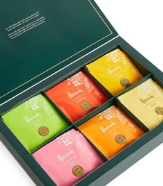 six different colored teas in a black box