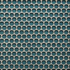 a close up view of a metal grate with circles on it