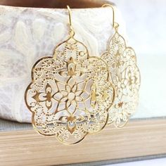 These are gorgeous gold filigree earrings! The Spanish lace design has intricate details and scalloped edges. These large dangle earrings are modern yellow gold plated and have simple fish hook ear wires. You can select them in rose gold at checkout. These would be beautiful for everyday or would be lovely accessories for a bridal party! Feminine, romantic and modern earrings that will soon become your favorite go-to accessories!These earrings measure approximately 2.5 inches and the filigree dr Big Gold Earrings, Spanish Lace, Gold Bridal Jewelry, Large Dangle Earrings, Gold Filigree Earrings, Gold Bridal Earrings, Dragonfly Earrings, Vintage Inspired Jewelry, Filigree Earrings