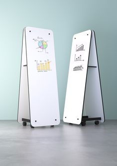 two white boards with drawings on them sitting next to each other