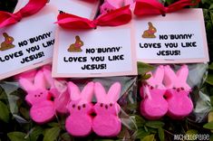 some pink peepies are tied up with red ribbon and tags that say no bunny loves you like jesus