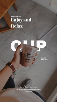 a person holding a cup with the words enjoy and relax on it