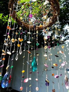 a wind chime hanging from a tree with lots of colorful glass beads and stones