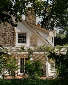 a white house surrounded by greenery and trees