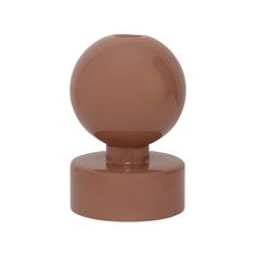 a brown plastic object on top of a white background