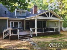 a house that is in the grass with stairs leading up to it's front porch