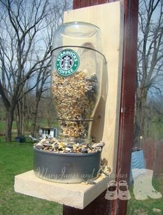 a glass jar filled with gold flakes sitting on top of a cement slab in front of a building