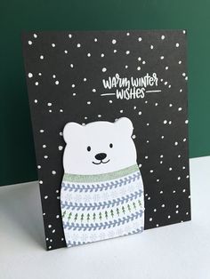 a card with a polar bear wearing a sweater on it's front and the words warm winter wishes written in white