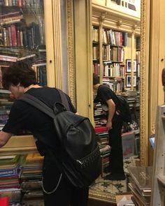 two people standing in front of a bookshelf