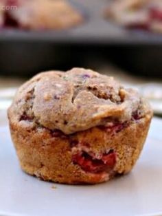 a muffin sitting on top of a white plate