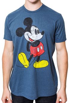 a man wearing a mickey mouse t - shirt