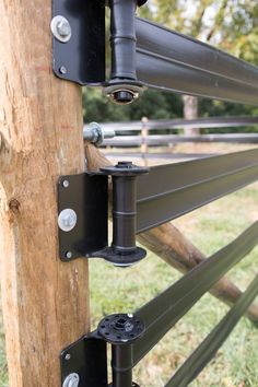 an image of a wooden fence with metal rails and brackets attached to the side of it