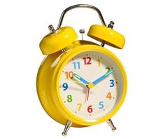 an alarm clock is yellow and has numbers on the front, two hands are visible