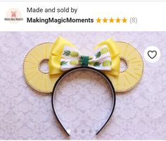 a mouse ears with a yellow bow and pineapples on the front, made by making magic moments