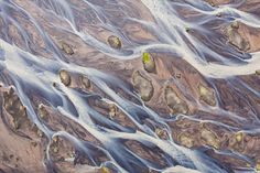 an aerial view of some very pretty rocks and water in the desert, as seen from space