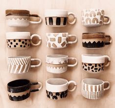 coffee cups are lined up on the wall