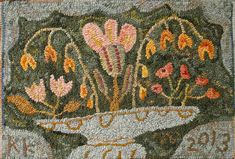 a close up of a rug with flowers on it