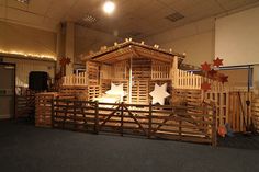 an image of a wooden structure with snowflakes on the roof and stars around it