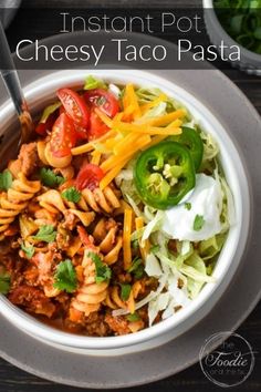 a white bowl filled with pasta and vegetables