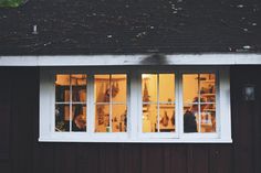 two people are seen through the windows of a house