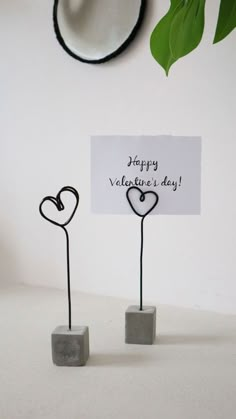 two hearts are placed on top of each other with a sign that says happy valentine's day