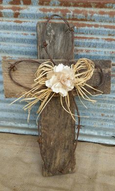 a wooden cross with a flower on it