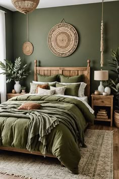 a bed with green sheets and pillows in a bedroom next to a window, potted plants