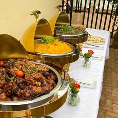 an assortment of food is displayed on a buffet table