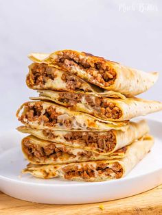 a white plate topped with quesadillas stacked on top of each other