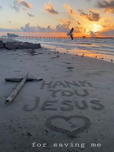 there is a message written in the sand on the beach with birds flying over it