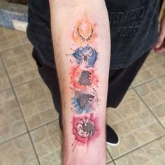 a person with a tattoo on their arm that has three different animals painted on it